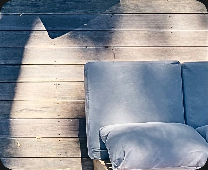 Outdoor seating on a sunlit community deck