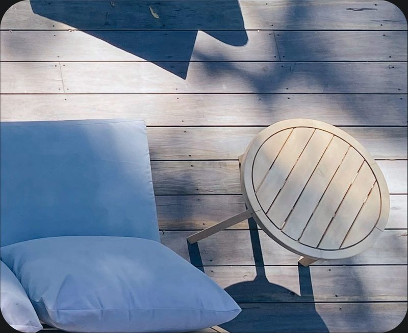 A patio chair and side table in a community common area