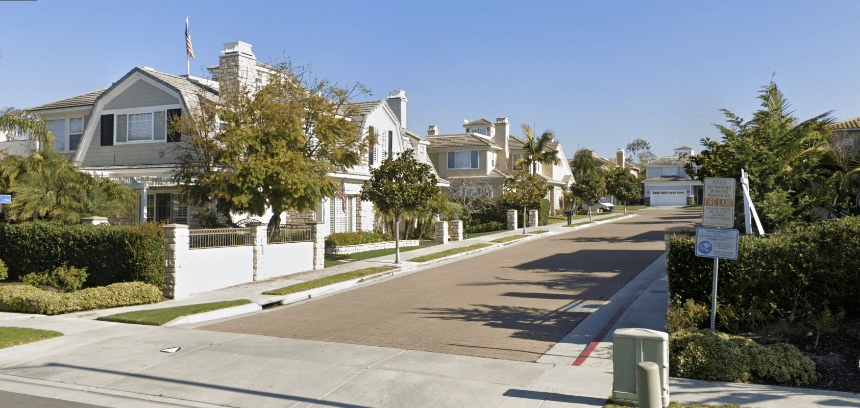 A photo of the Via Saratoga community, a small street with large, gambrel-roofed homes